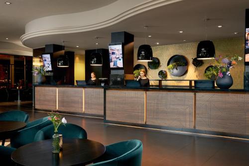 two women sitting at a bar in a restaurant at Van der Valk Theaterhotel Almelo in Almelo