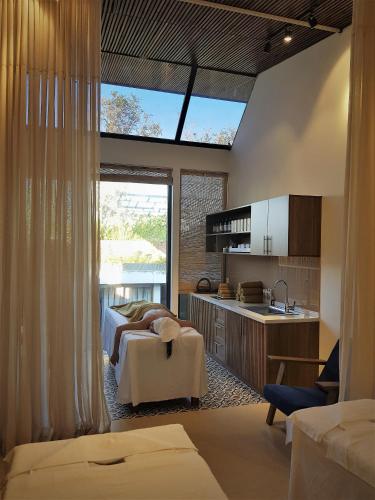 a large bedroom with two beds and a kitchen at Mai's Boutique in Da Nang