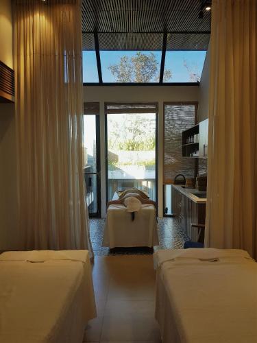 a bedroom with two beds and a large window at Mai's Boutique in Da Nang