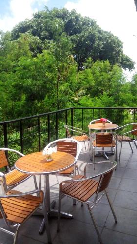 a group of tables and chairs on a balcony at Eden Blue in Thulusdhoo