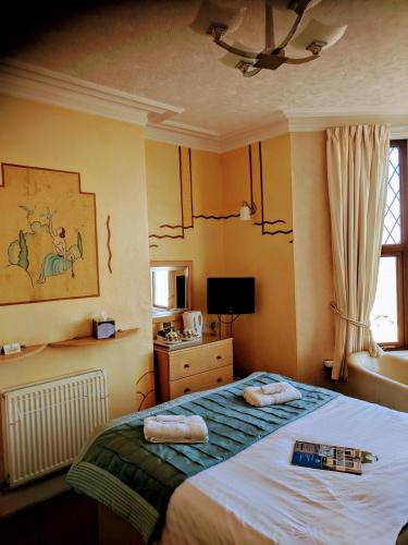 a bedroom with a bed with towels on it at Craigwell in Morecambe