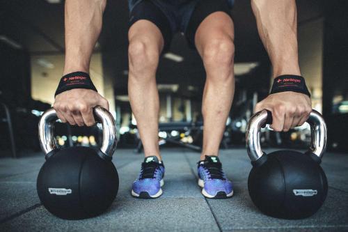 a man is holding weights in a gym at Club Marvy in Ozdere