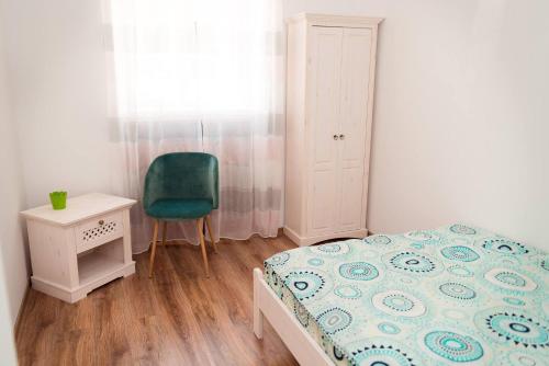 a bedroom with a bed and a chair and a table at ★ 2 minute walk from the Bridge of Lies ★ in Sibiu