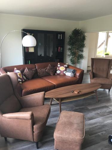 a living room with a brown couch and a coffee table at Apartement "Sam" in Wilhelmshaven