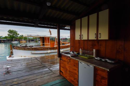 eine Küche auf einem Dock mit einem Boot im Wasser in der Unterkunft Urke - Ada Bojana in Ulcinj