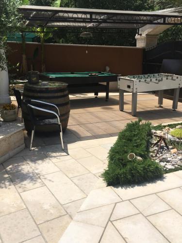 a patio with a ping pong table and a ping pong table at Apartments Barbara in Poreč