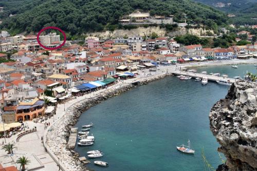 a small town with boats in the water at San Nectarios in Parga