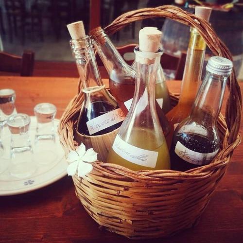 a basket of bottles of wine on a table at Trulli Panoramici in Alberobello