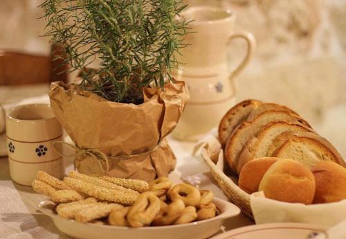 a table with a plate of bread and some snacks at Trulli Panoramici in Alberobello