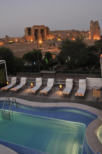 a swimming pool with lounge chairs and a building at M/Y Alexander The Great Nile Cruise - 4 Nights Every Monday From Luxor - 3 Nights Every Friday from Aswan in Luxor