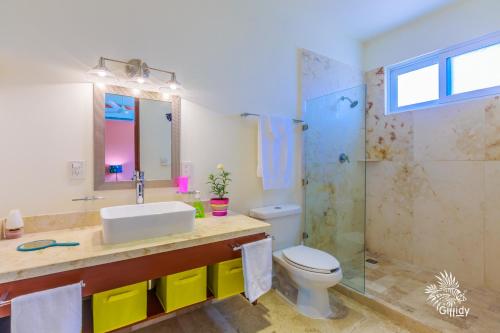 a bathroom with a sink and a toilet and a shower at Estrella del Mar - Condo 101 in Isla Mujeres