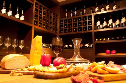 a table with a bunch of food and wine glasses at Kenton Palace Buenos Aires in Buenos Aires