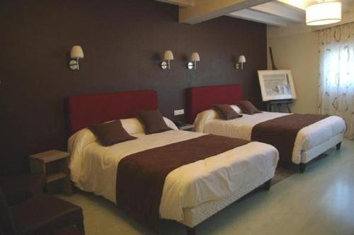 a hotel room with two beds in a room at Hôtel Saint-Hubert in Saint-Claude