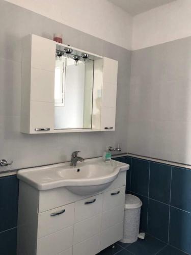 a bathroom with a white sink and a mirror at Marina's Studios Serifos in Livadi