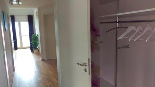 a room with a closet with a door and a hallway at FeWo - bei Tati 95qm in Singen