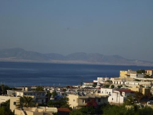 a city with houses and the ocean in the background at Aethrio Guesthouse in Souvala