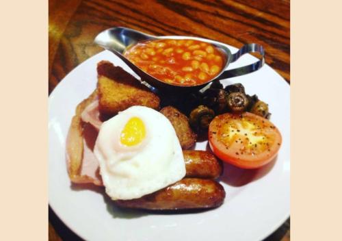 a plate of breakfast food with eggs bread and beans at Arlington Hotel O'Connell Bridge in Dublin