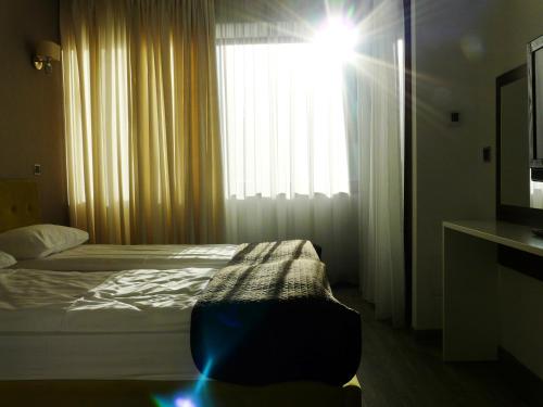 a bedroom with a bed and a large window at Silver Mountain Apartment A32 - 3 rooms 3 bathrooms in Poiana Brasov