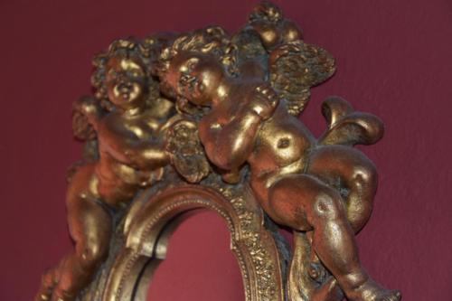 a gold statue of a cherbourg reflecting in a mirror at Agriturismo Gocce di Luna in Celle Ligure