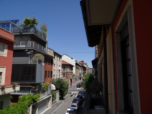 a city street with cars parked on the side of a building at Hotel Amendola Fiera in Milan