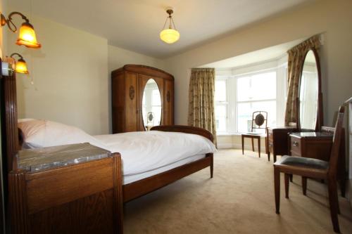 a bedroom with a large bed and a window at 81 Eastgate in Cowbridge