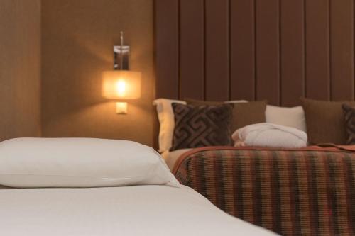 Ένα ή περισσότερα κρεβάτια σε δωμάτιο στο Your Hotel & Spa Alcobaça