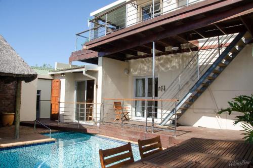 a house with a swimming pool next to a building at Goulden Street Guest House in East London