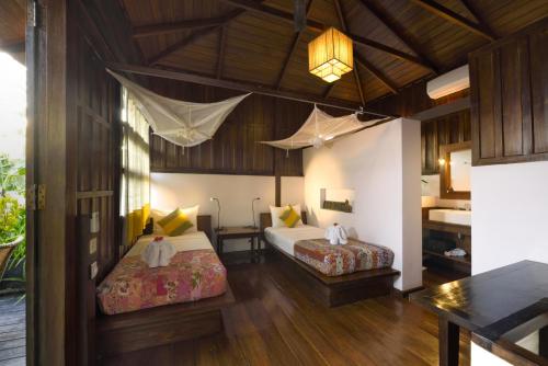 Postel nebo postele na pokoji v ubytování La Maison Birmane Boutique Hotel