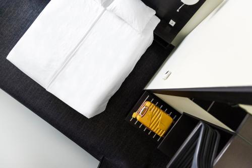 a close up of a bed with a white pillow at Comfort Hotel LT - Rock 'n' Roll Vilnius in Vilnius
