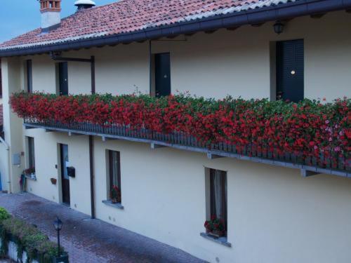 a building with red flowers on the side of it at Locanda dell'Oca Bianca in Como