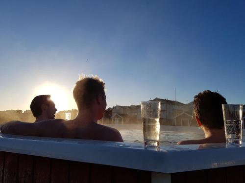 a group of people in a bathtub with a drink at Sea Lodge Smögen in Smögen