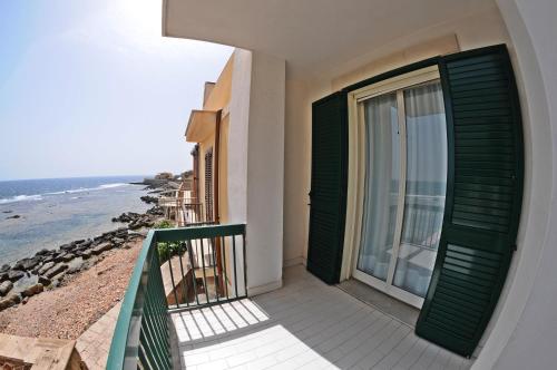 a balcony of a building with a view of the ocean at Thalìa Guest House Marzamemi in Marzamemi