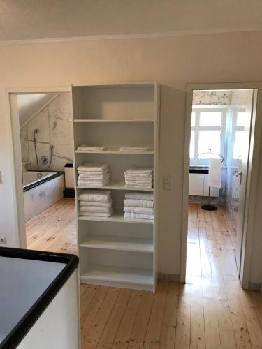 a room with a closet with white shelves at Kranenbruch in Schwalmtal