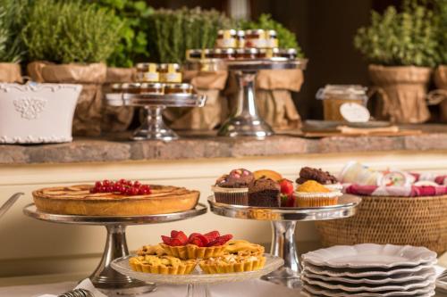 a buffet with several trays of desserts and pies at Locanda I Girasoli in Misano Adriatico