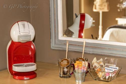 a red coffee maker sitting on top of a table at Laguna Lodge in Graskop