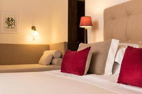 a bedroom with a bed with red and white pillows at Locanda I Girasoli in Misano Adriatico