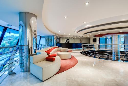 a lobby on a cruise ship with couches and chairs at Senator Banus Spa Hotel in Estepona