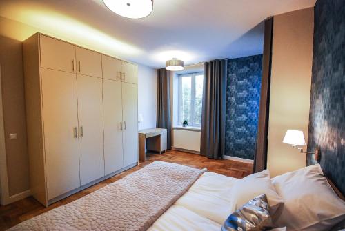 a bedroom with a large bed and a window at Apartament Sokoła in Łańcut