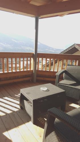 a patio with a table and chairs on a deck at Römerstraße 10 KG, Appartement Inntal in Innsbruck