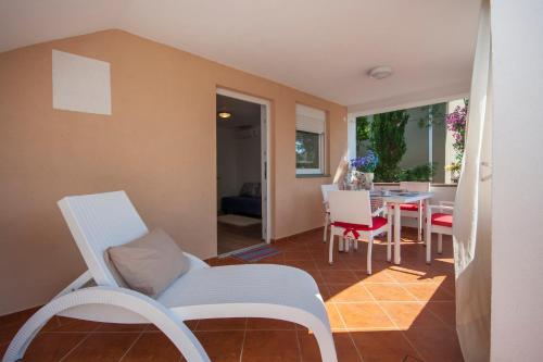 a living room with a chair and a table at Apartmani Luka in Vir