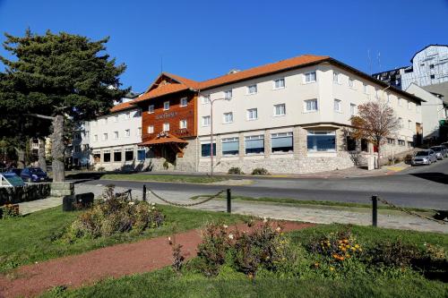 a building on the side of a street at Hotel Tres Reyes in San Carlos de Bariloche