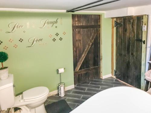 a bathroom with a toilet and a sliding door at Co-ed Dorm with Fantastic Patio! in Ewing