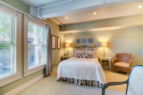 a bedroom with a bed and two windows at Winchester Inn in Ashland
