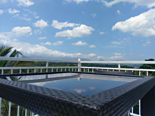 a pool on the balcony of a house with a bridge at Mahaweli View Inn in Kandy