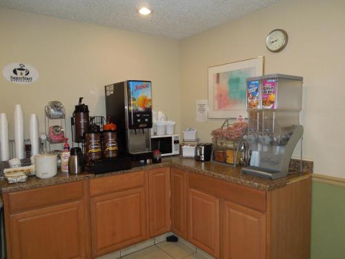 a coffee shop with a counter with a coffee maker at Super 8 by Wyndham Harrisonburg in Harrisonburg