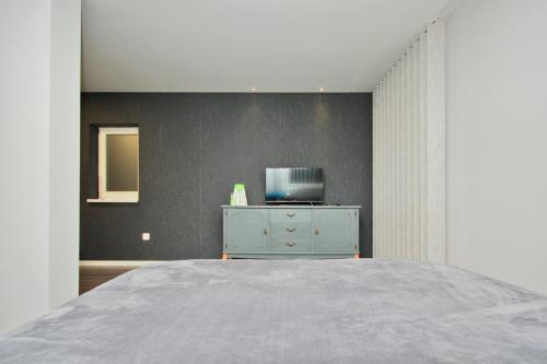 a bedroom with a blue dresser and a bed at Apartman Amaya in Sarajevo