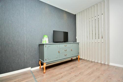 a room with a dresser with a television on it at Apartman Amaya in Sarajevo