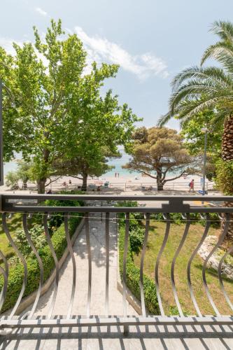 a view of the beach from a bench at Guesthouse on the beach in Baška Voda