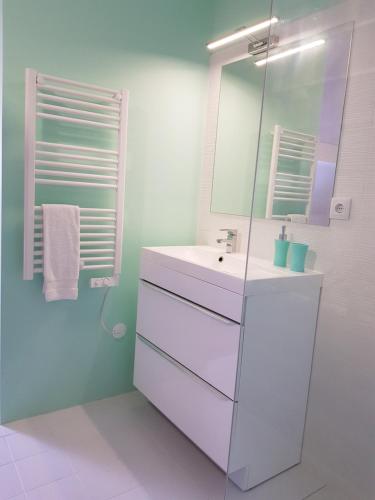a white bathroom with a sink and a mirror at OHH - Porto Boutique Guest House in Porto