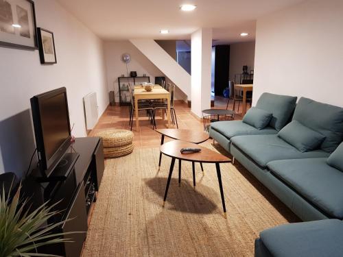 a living room with a couch and a tv at OHH - Porto Boutique Guest House in Porto